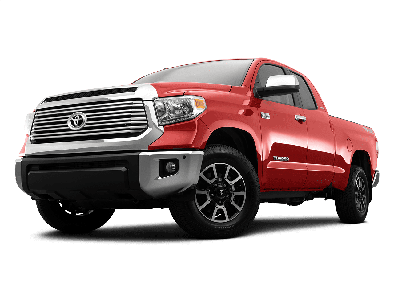 A red Toyota Tundra pickup truck is shown from a low-angle front three-quarter view. The truck features a prominent chrome grille with the Toyota emblem in the center, large headlights, and black alloy wheels. The word 'Tundra' is visible on the side of the truck bed. The truck has a robust and sturdy appearance, highlighting its capability and strength.